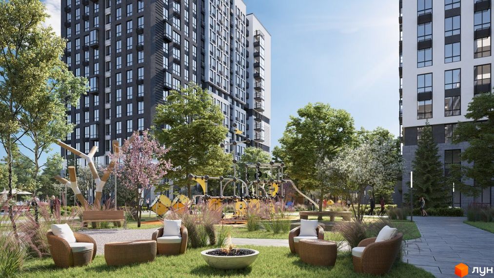 Зовнішній вигляд висотних будинків ЖК Vyshgorod Sky та зелена прибудинкова територія з дитячим майданчиком та зонами відпочинку.