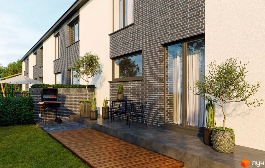 Сучасний житловий комплекс з цегляним фасадом та просторою прибудинковою територією з барбекю та зеленими насадженнями.