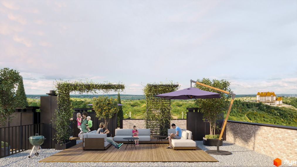 Тераса житлового комплексу WAWEL з дитячою зоною та зоною відпочинку. Відкривається вид на зелені пагорби та будівлю вдалині.