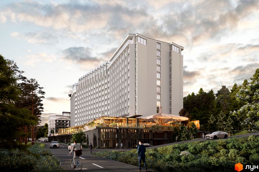 Апарт-комплекс Mountain Residence з багатою зеленою прибудинковою територією та дорогою з автомобілями та пішоходами.