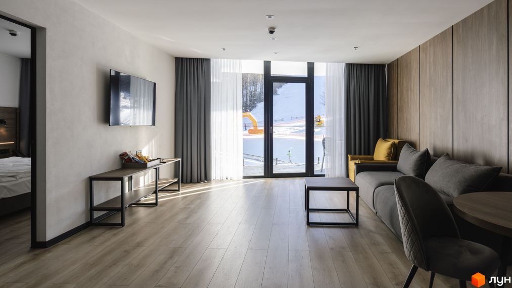 Апарт-комплекс Mountain Residence з видом на гірськолижний схил. Просторий номер з диваном, телевізором та балконом.