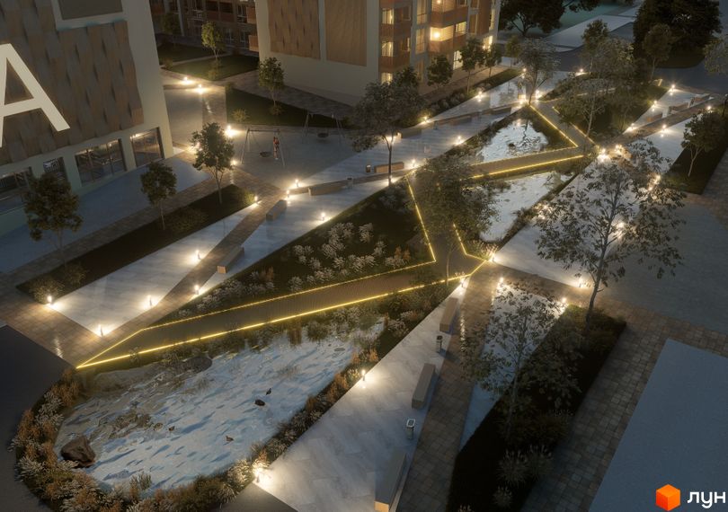 Житловий комплекс AUROOM DISTRICT з архітектурним освітленням та доглянутою прибудинковою територією з водоймою, лавками та деревами.
