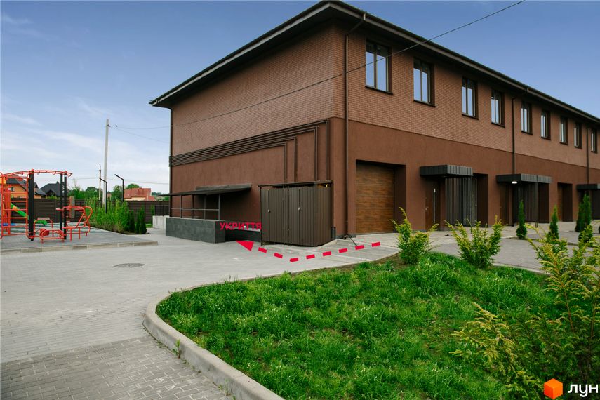 Зовнішній вигляд будинку в Житловому комплексі клубного типу Обрій. На території є зелені насадження та дитячий майданчик.