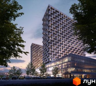BOSTON Creative House: дві високі будівлі з візерунчастими фасадами та скляним комерційним поверхом, оточені деревами та парковкою.